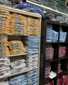 Stockroom shelves of bagged uniforms ready to ship.